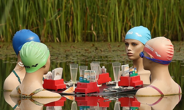 mannequins in swim caps in a circle in a pond playing Keno